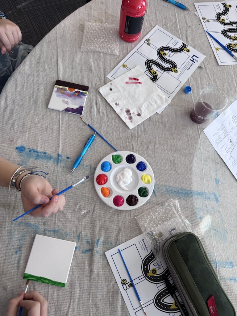 Image shows students engaging in the coaster painting creative session.