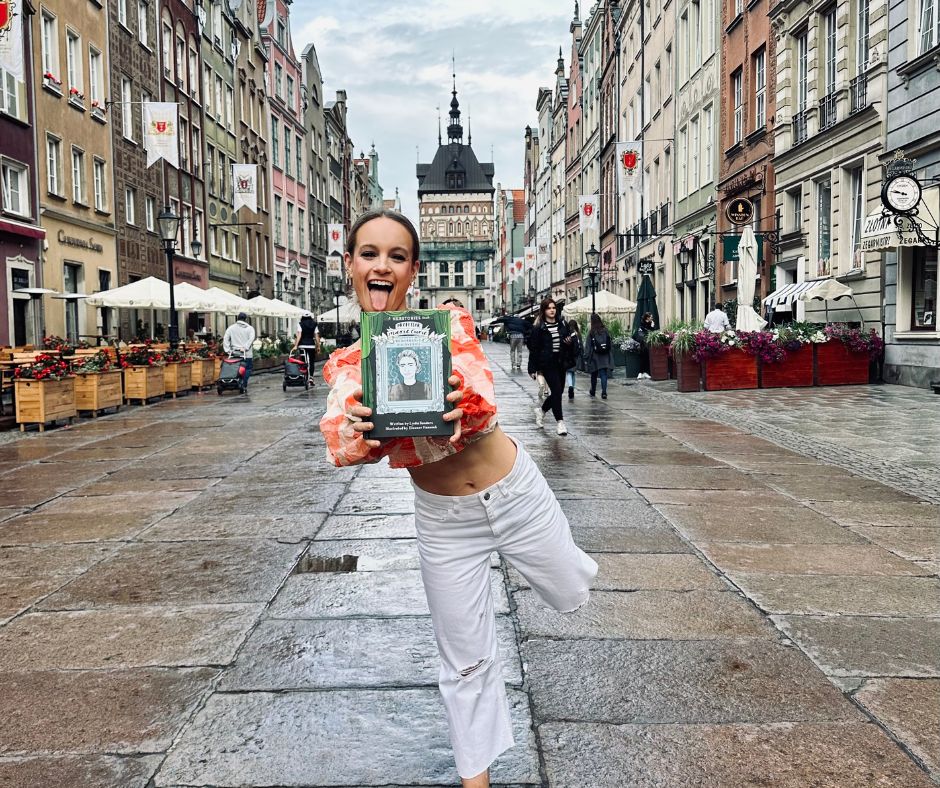 An image of Lydia Sanders holding one of her publications.