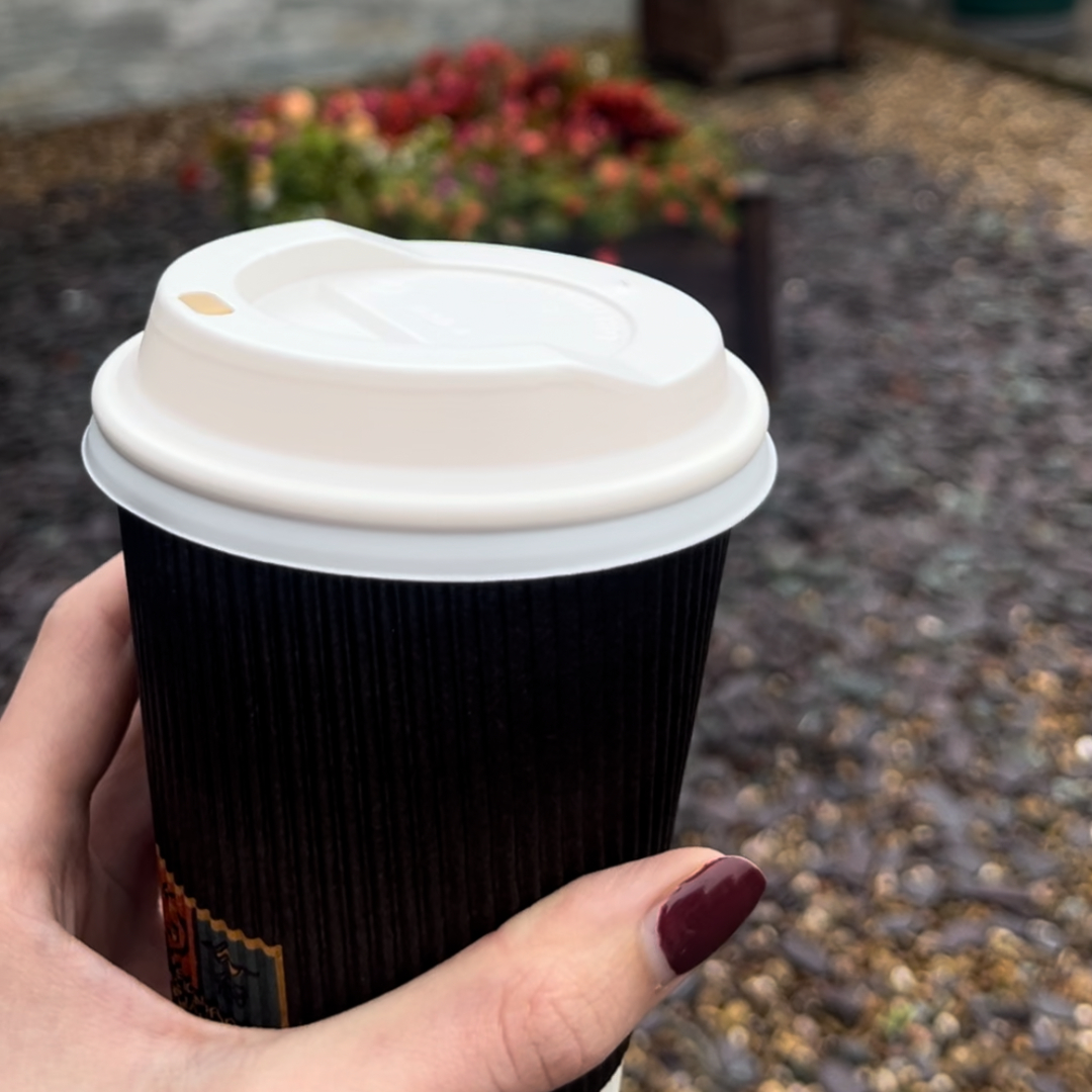 Image shows a takeaway cup of coffee.